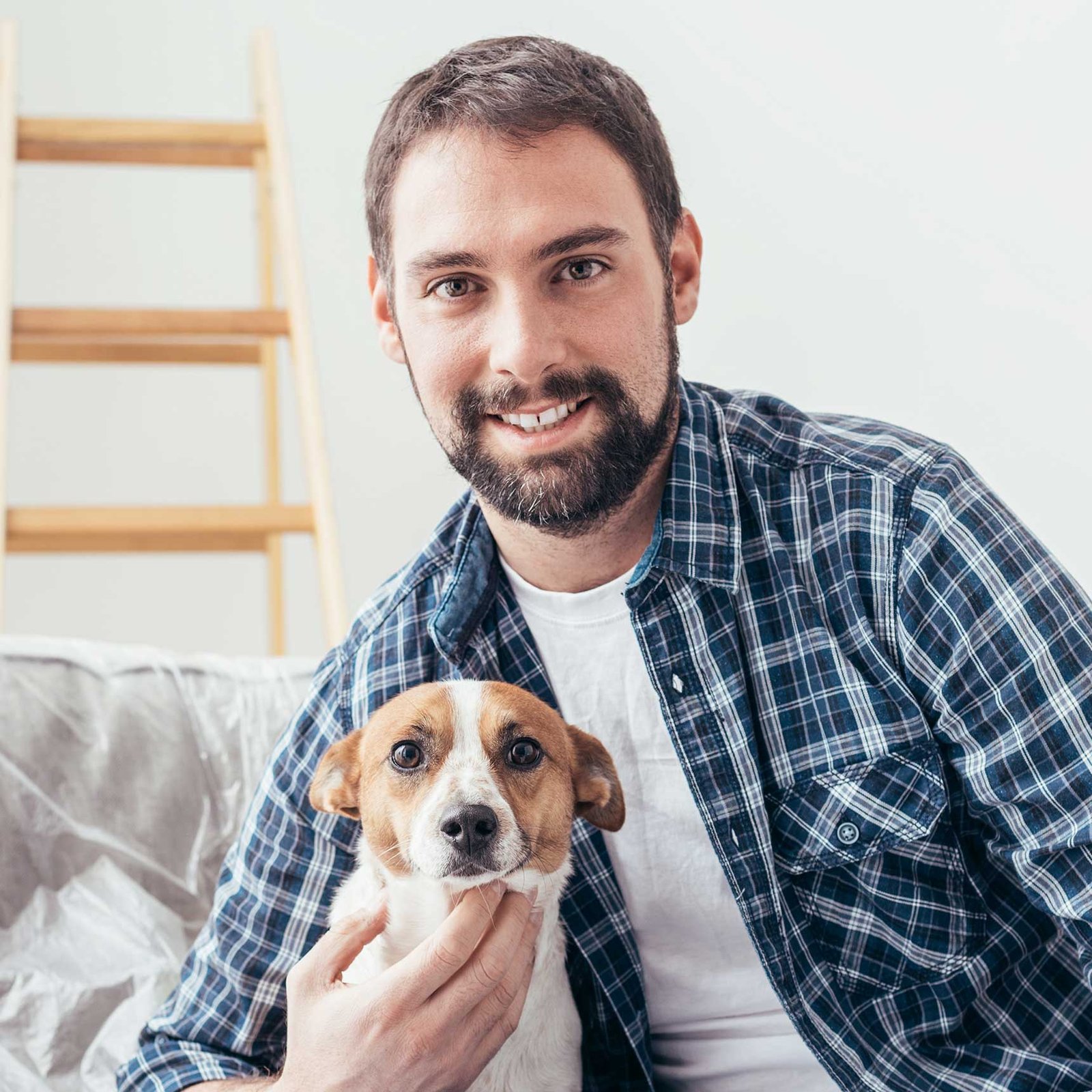 Dog owner checking a dog coat at home